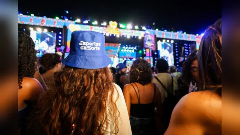 Pessoa de costas com boné promocional durante evento.