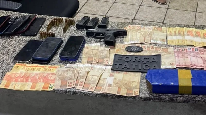 Armas, munições e dinheiro apreendidos pela Polícia Militar.