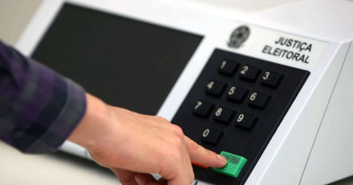 Urnas eletrônicas dispostas em fila para votação.